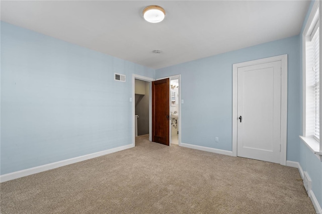 unfurnished bedroom featuring carpet, a closet, visible vents, and baseboards