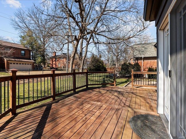 wooden deck featuring a yard and fence