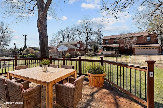 wooden deck featuring outdoor dining space, a lawn, and fence