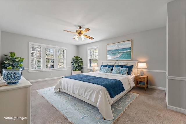 bedroom featuring light carpet, ceiling fan, and baseboards