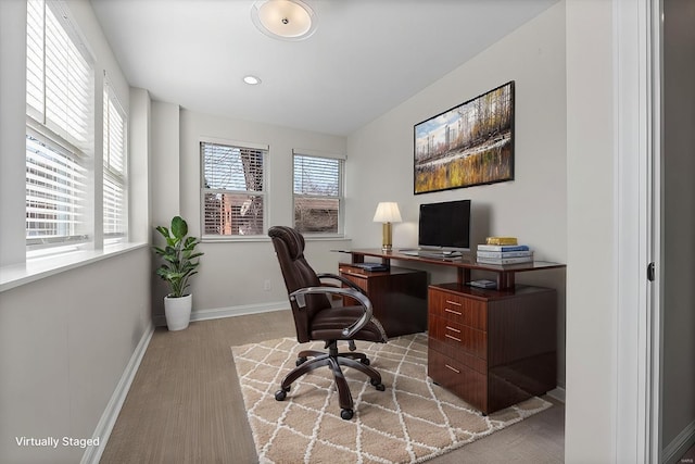 office area featuring light wood-type flooring and baseboards