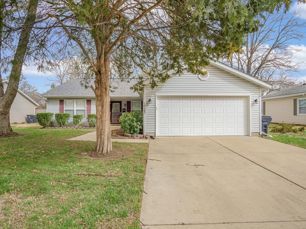 single story home with an attached garage, concrete driveway, and a front lawn