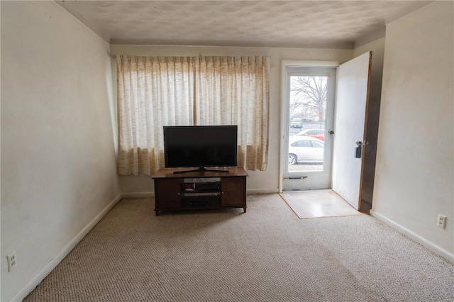 living room featuring light carpet and baseboards