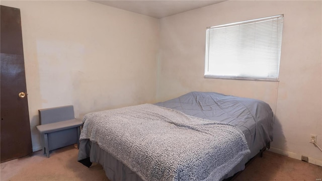 carpeted bedroom featuring baseboards