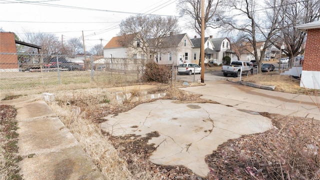 view of yard featuring a residential view and fence