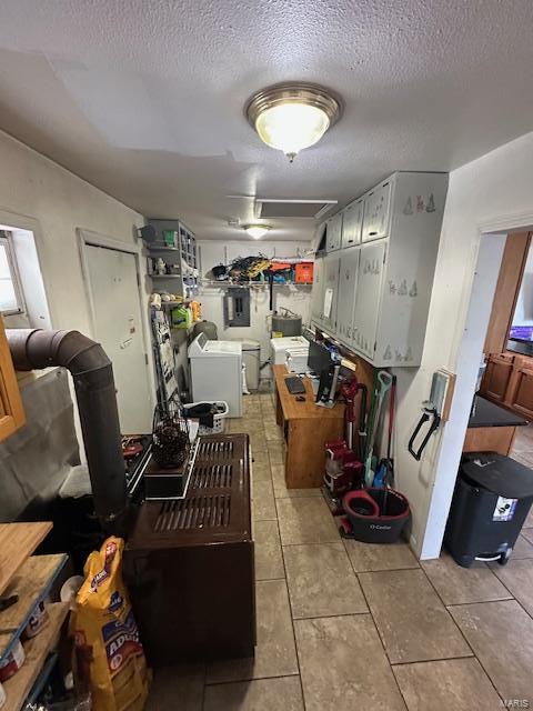 kitchen featuring light tile patterned floors, separate washer and dryer, and a textured ceiling