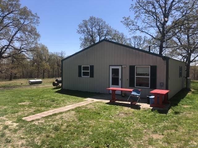 view of property exterior featuring a lawn