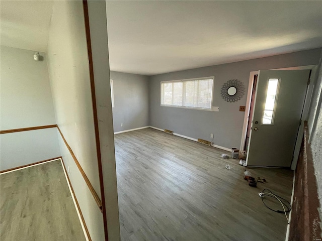 entrance foyer featuring baseboards and wood finished floors