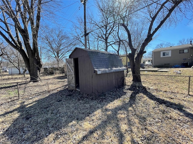 view of yard with a fenced backyard, an outdoor structure, and a shed