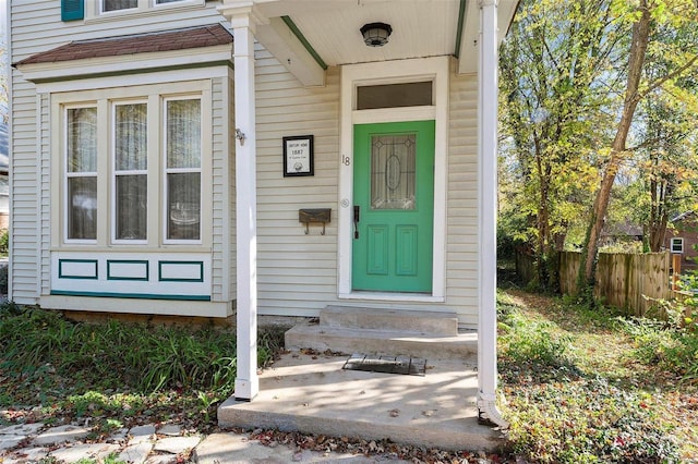 view of exterior entry featuring fence