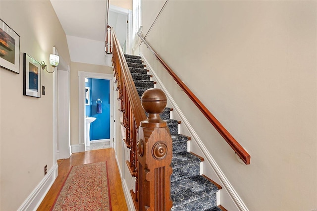 stairs with baseboards and wood finished floors