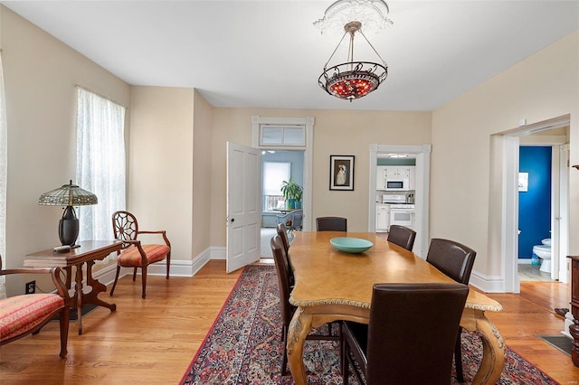 dining room featuring light wood-style floors and baseboards