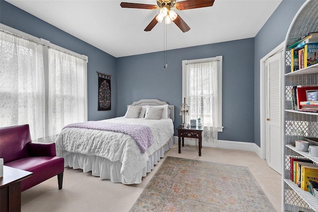 bedroom featuring a closet, carpet flooring, a ceiling fan, and baseboards