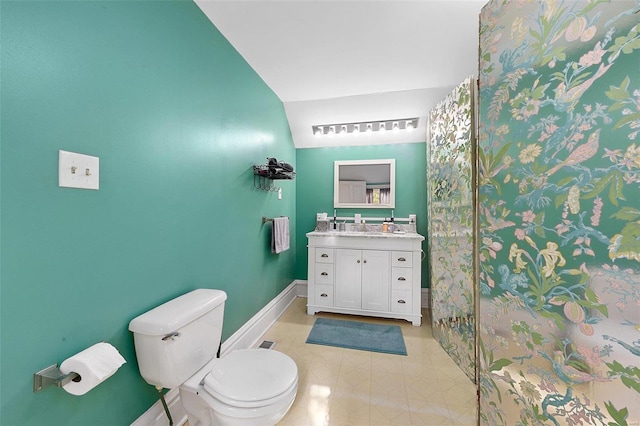 bathroom with toilet, visible vents, vanity, vaulted ceiling, and baseboards