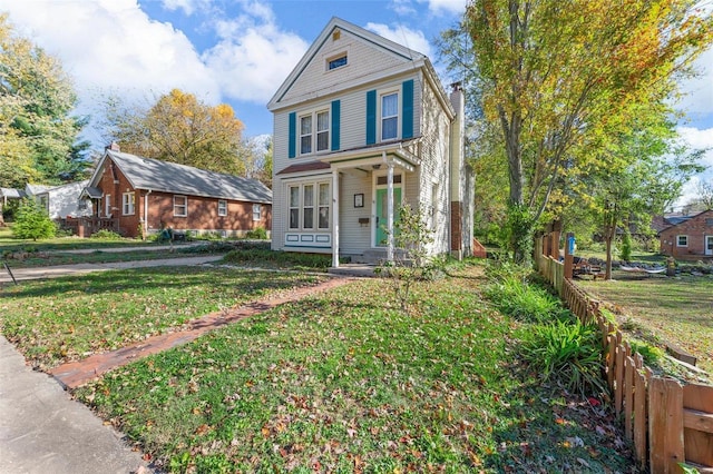 traditional-style home with fence and a front lawn