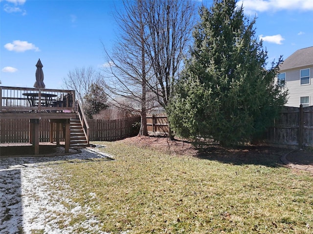 view of yard with a deck, stairway, and a fenced backyard