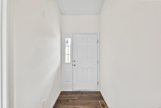 entryway with dark wood-style floors, visible vents, and baseboards