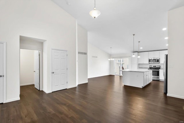 kitchen with dark wood-style floors, light countertops, appliances with stainless steel finishes, and white cabinets