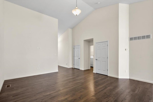 unfurnished room featuring high vaulted ceiling, dark wood-style flooring, visible vents, and baseboards