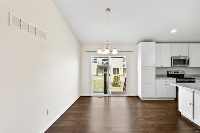 kitchen with visible vents, white cabinets, dark wood finished floors, stainless steel appliances, and a notable chandelier