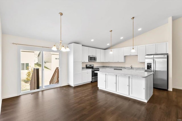 kitchen with dark wood-style floors, appliances with stainless steel finishes, white cabinets, and a center island