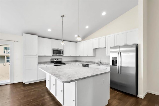 kitchen featuring white cabinets, appliances with stainless steel finishes, a center island, light countertops, and a sink