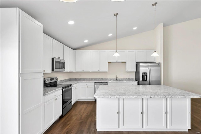 kitchen featuring lofted ceiling, a kitchen island, appliances with stainless steel finishes, white cabinetry, and a sink