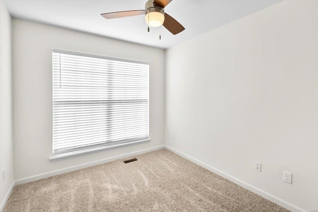 unfurnished room featuring ceiling fan, carpet, visible vents, and baseboards