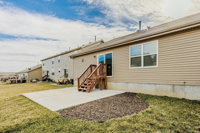 back of house with a yard and a patio