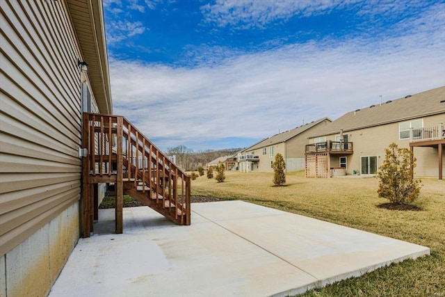 view of yard featuring a patio, stairway, and a residential view