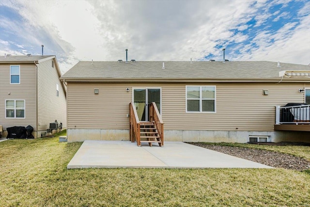 rear view of house featuring entry steps, a patio area, central air condition unit, and a lawn