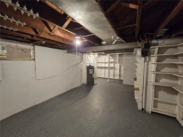 unfinished basement with electric water heater