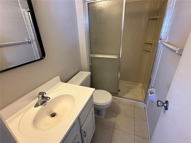 full bathroom featuring vanity, tile patterned flooring, toilet, and a shower stall