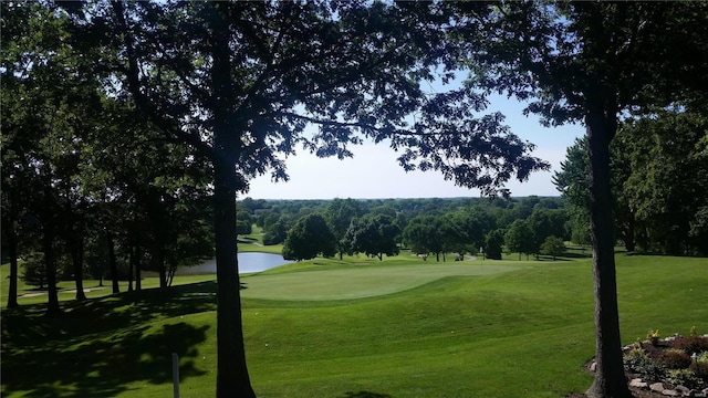 view of property's community featuring view of golf course, a water view, and a yard