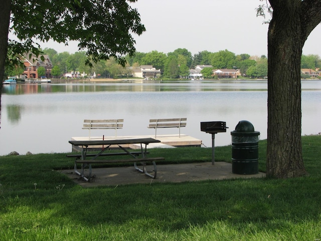 exterior space featuring a yard and a water view