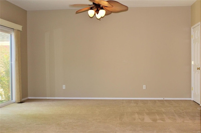 spare room featuring baseboards, ceiling fan, and light colored carpet