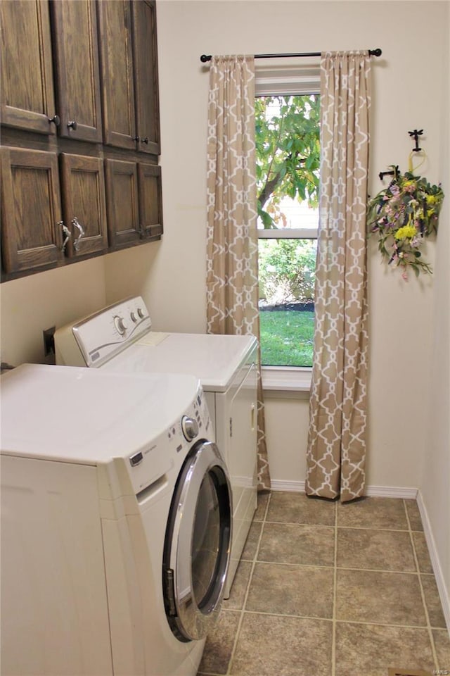 laundry room with cabinet space, tile patterned flooring, baseboards, and separate washer and dryer