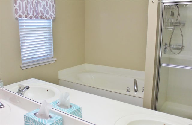 full bathroom with double vanity, a stall shower, a sink, and a bath