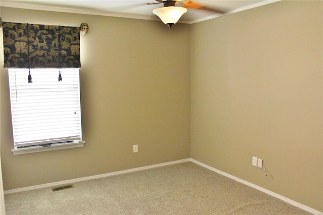 carpeted spare room featuring ceiling fan, visible vents, and baseboards