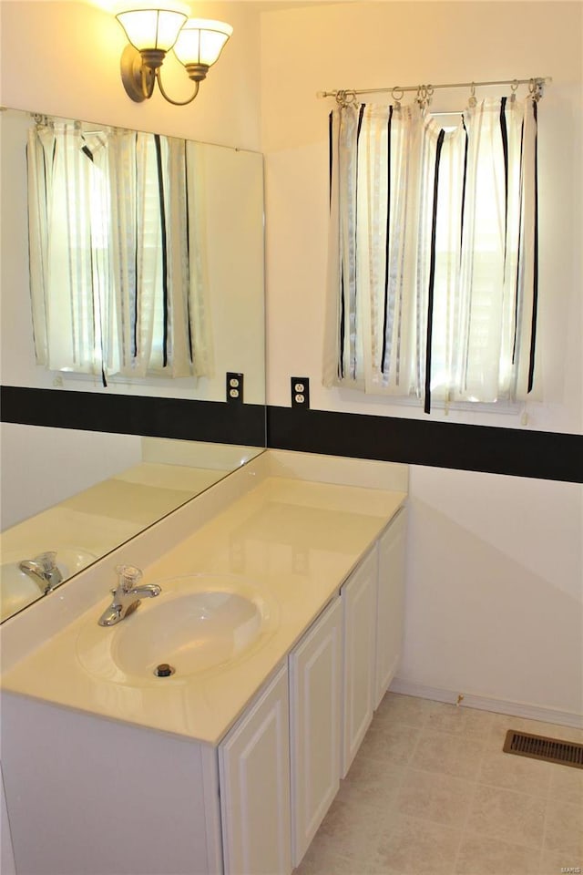 bathroom with visible vents and vanity