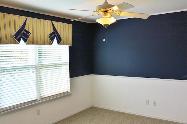 unfurnished room with light carpet and a ceiling fan