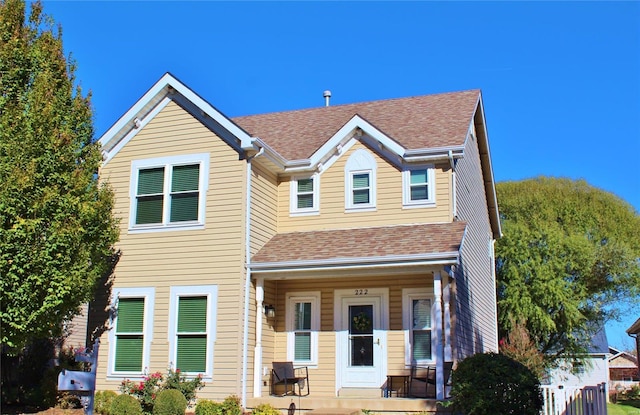 view of front of property with covered porch and roof with shingles