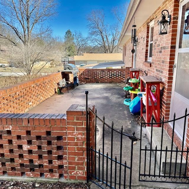 view of patio / terrace featuring a gate and fence