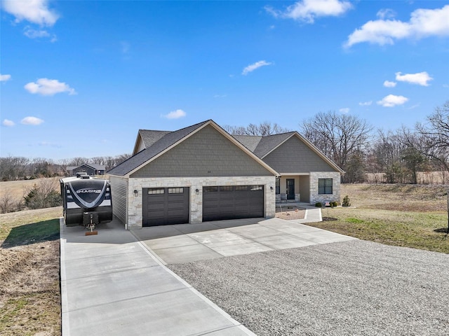 view of front of home with a garage, stone siding, and concrete driveway