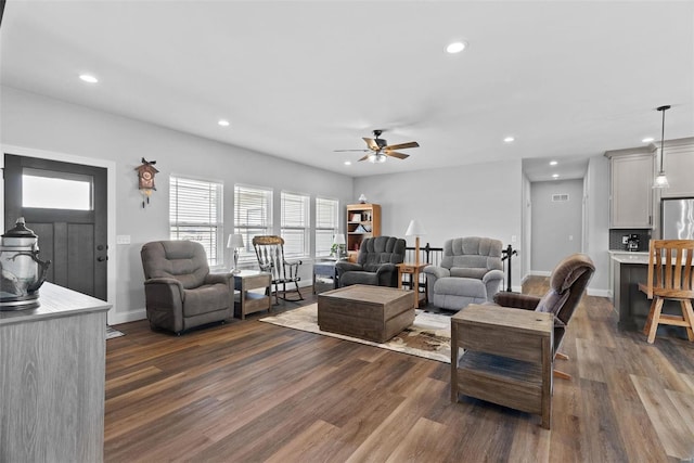 living room with recessed lighting, dark wood-style floors, and baseboards