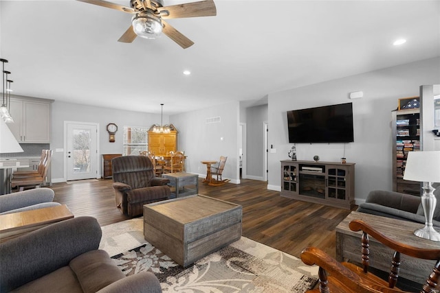 living area with recessed lighting, wood finished floors, and baseboards