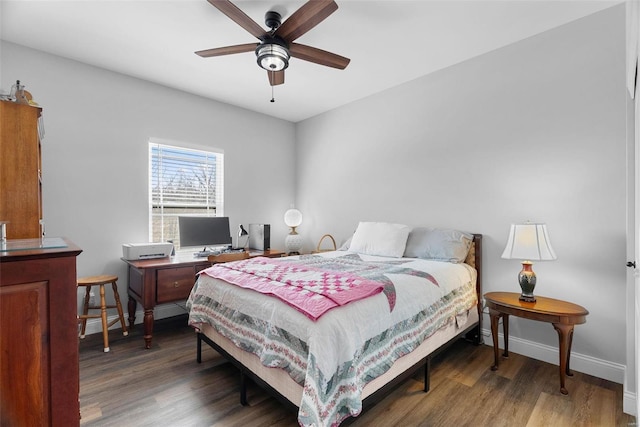 bedroom with a ceiling fan, wood finished floors, and baseboards