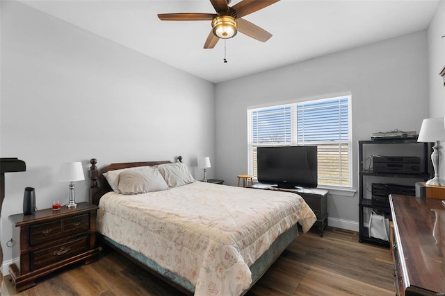 bedroom featuring ceiling fan, baseboards, and wood finished floors