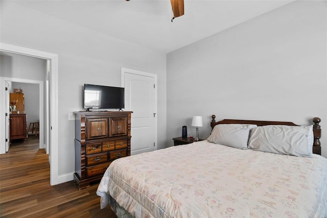 bedroom featuring ceiling fan, baseboards, and dark wood finished floors