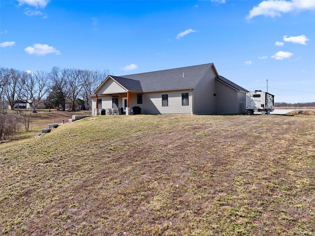 rear view of house featuring a yard